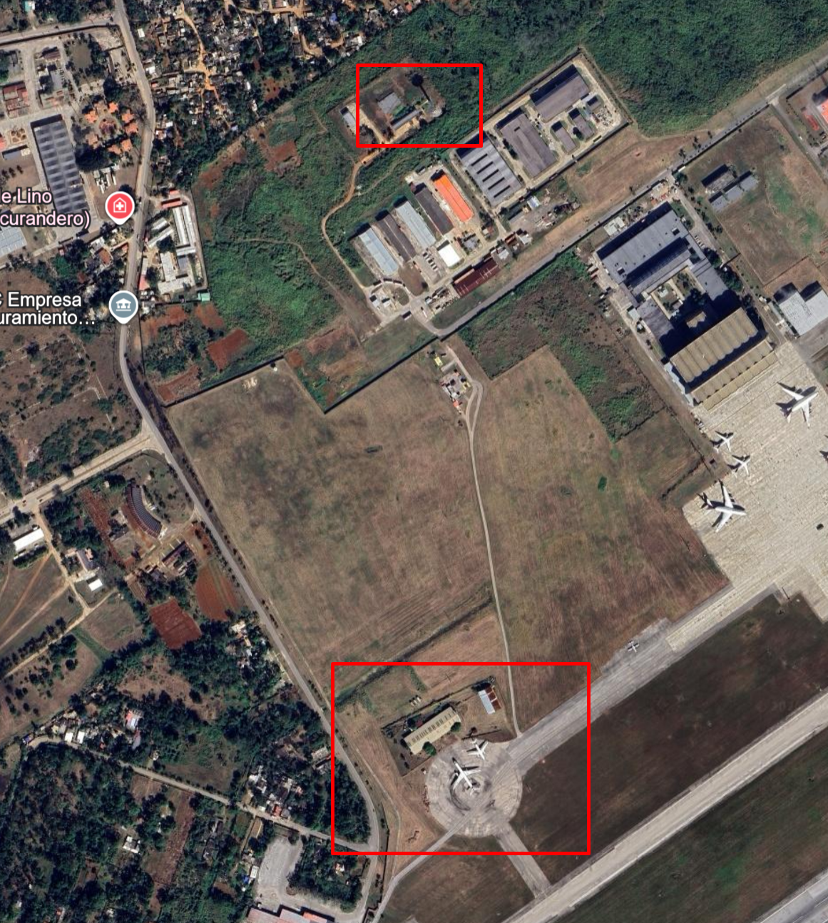 Wider satellite view showing the circular apron at the bottom and a building near the top, both highlighted with red boxes.