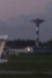 Cropped detail from the original challenge photograph showing the control tower faintly visible in the background.