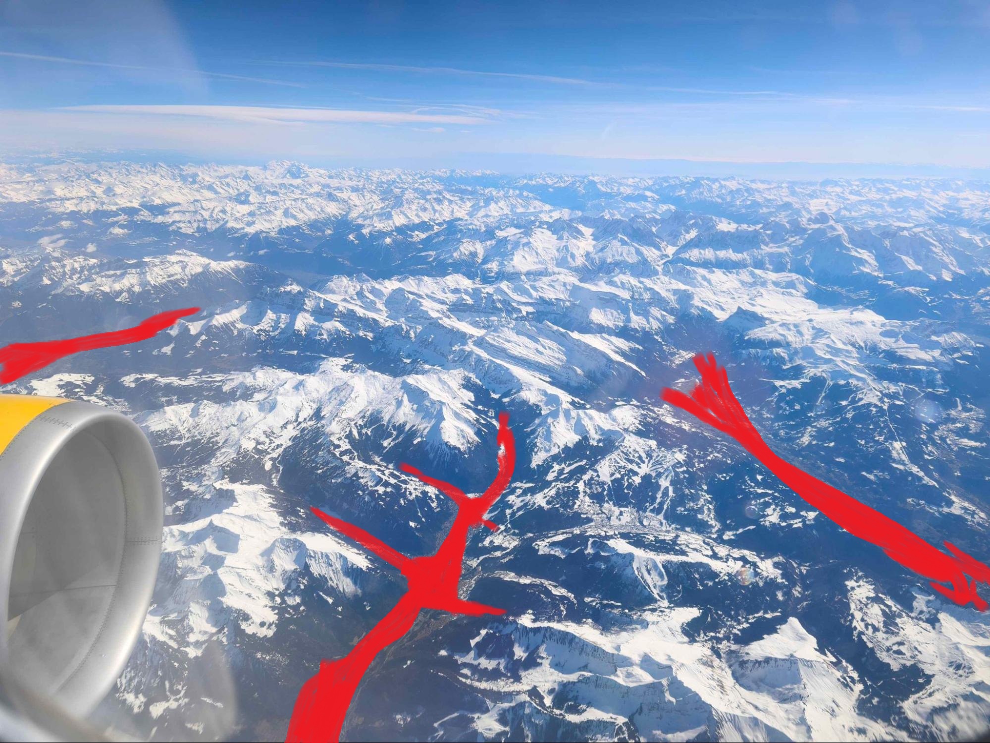 The original window seat photo with the same valley shapes painted in red.