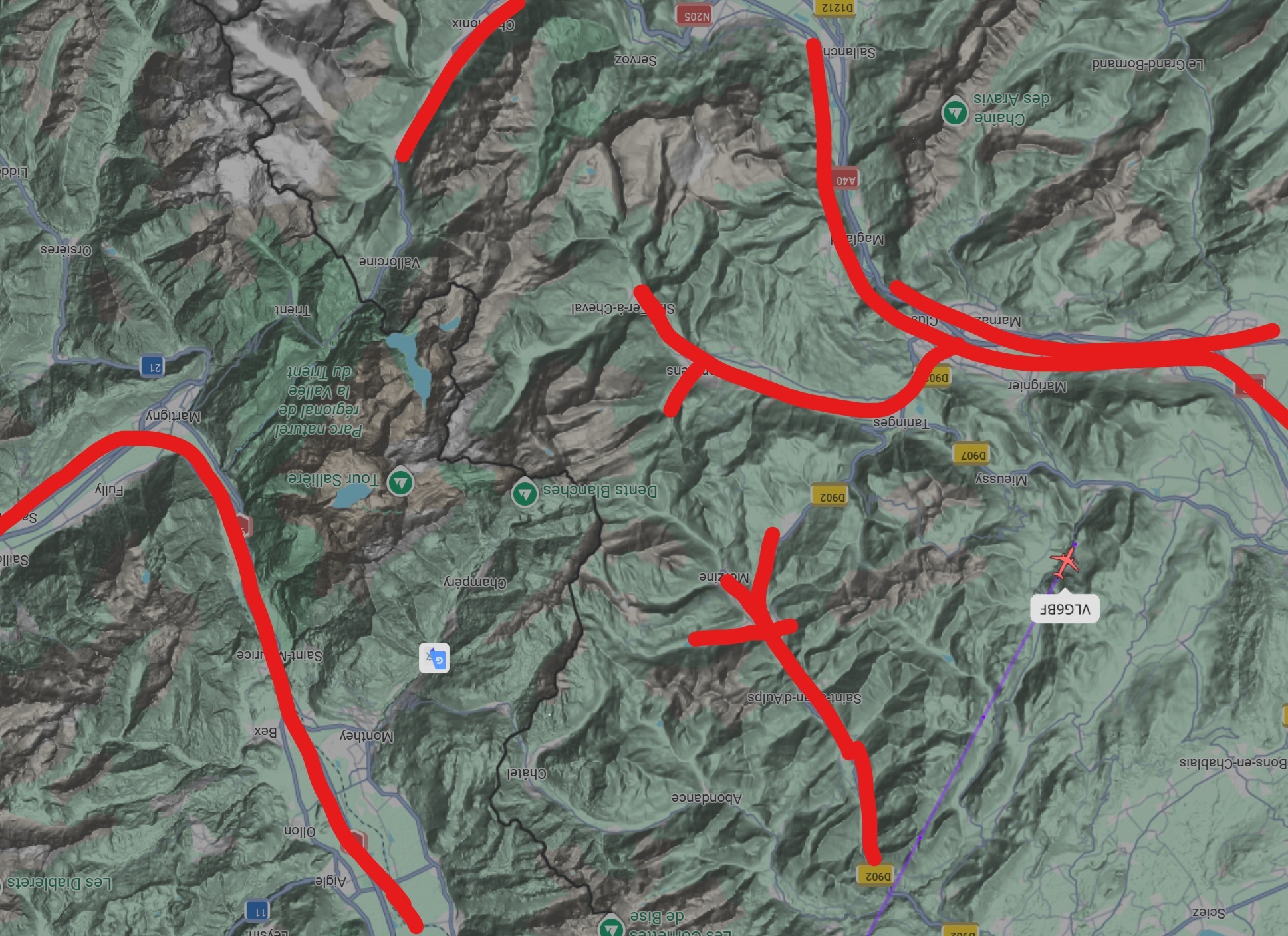 Satellite map view of the Alps with valley shapes painted in red turned 180 degrees to match the photo angle.