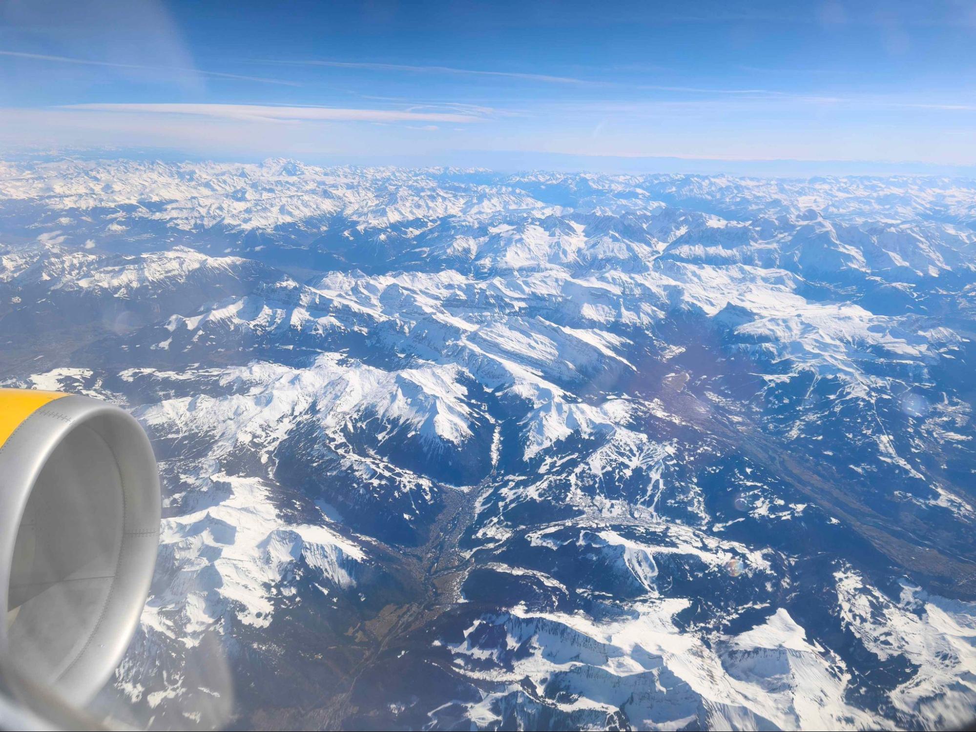 The original challenge photo showing a plane wing in the front and snowy mountains below.